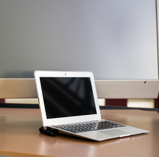 A used laptop PC, sitting on a desk.